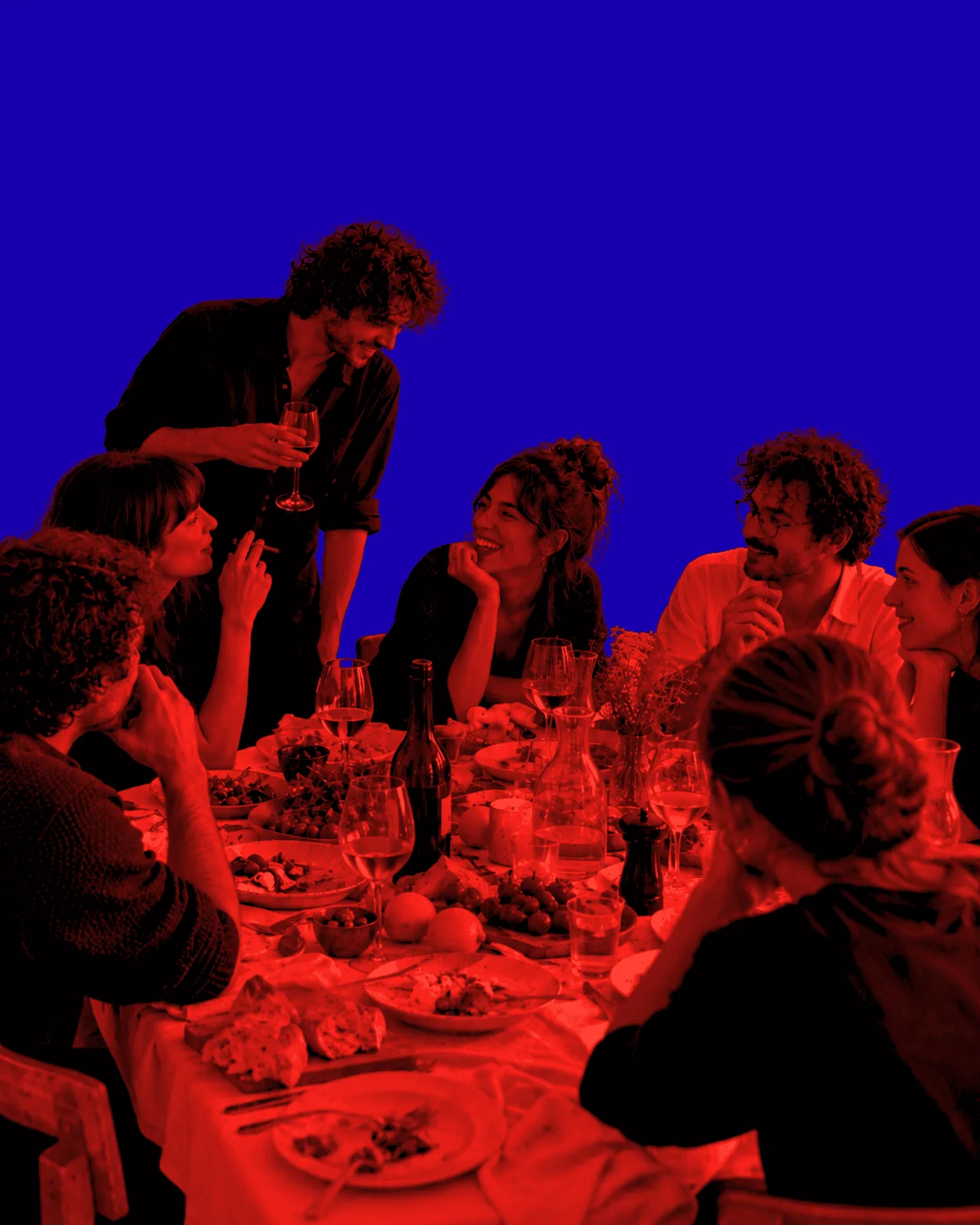 Artists at a HUSH table, lit red against deep blue